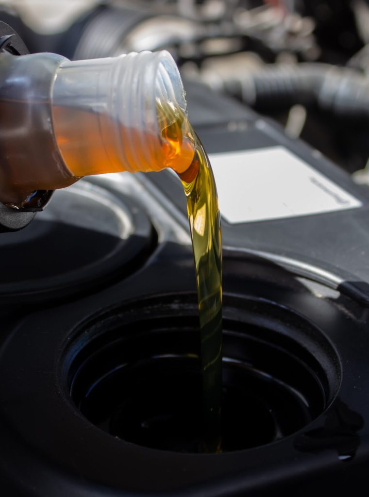 Refueling and pouring oil quality into the engine motor car Transmission and Maintenance Gear .Energy fuel concept. selective focus
